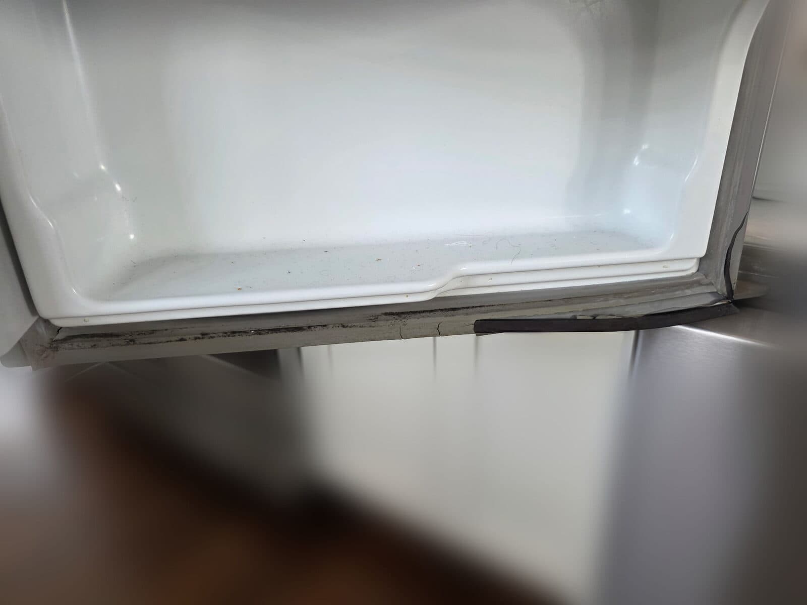 Cracked and torn freezer drawer gasket that no longer seals